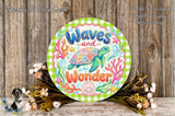 A round sign with the text "Waves and Wonder" surrounded by colorful illustrations of a turtle, coral, and seaweed, placed on a wooden surface with flowers.