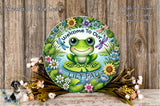 a green frog sitting on top of a wooden table