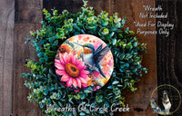 a picture of a wreath with a bird and flowers on it
