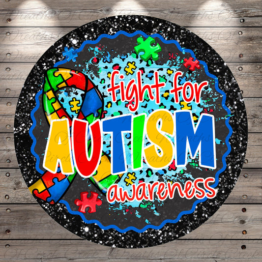 The image is a circular graphic with a puzzle ribbon and the text "fight for Autism awareness" written on it.