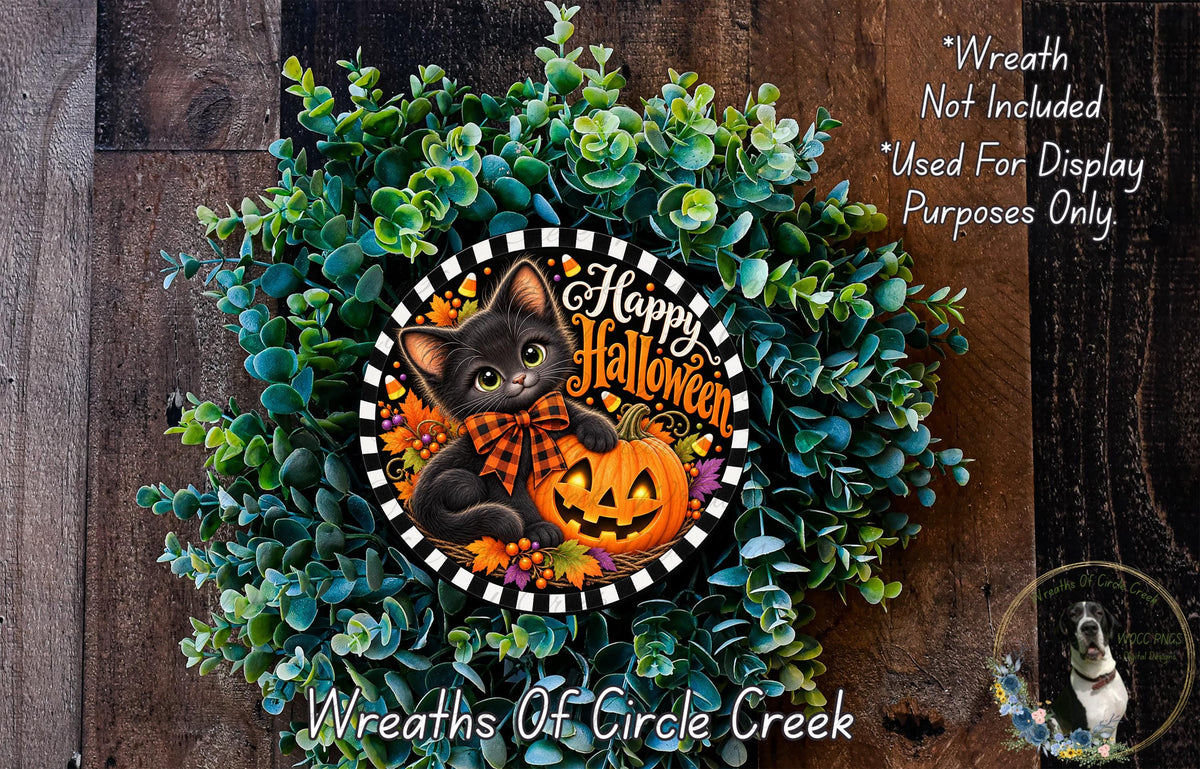 A Halloween-themed wreath made of green foliage and a carved jack-o-lantern. The wreath has a black cat and a pumpkin as the main decorative elements.