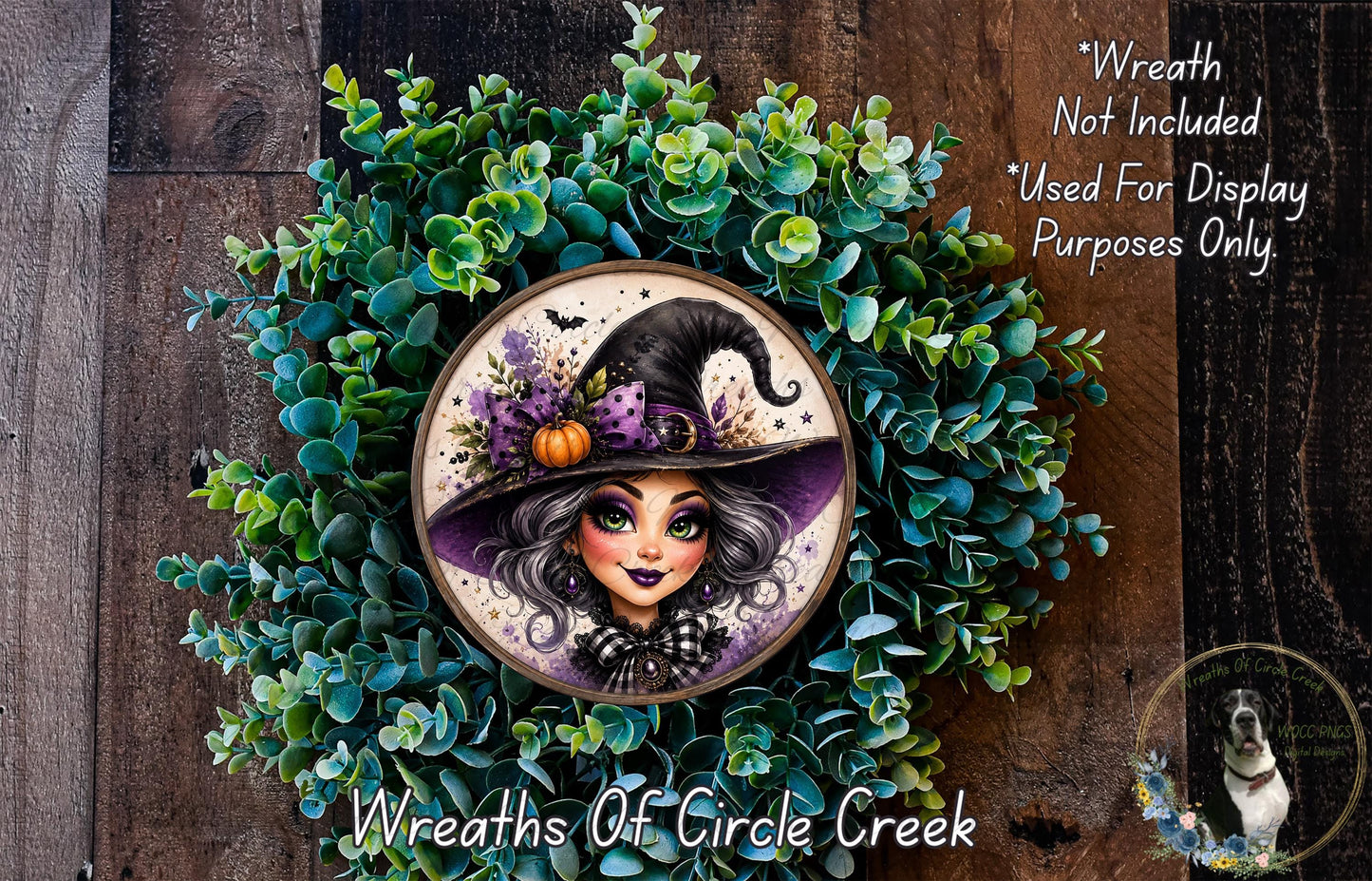 A wreath featuring a woman with a witch's hat, surrounded by green foliage.