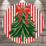A festive Christmas tree decoration with a red bow and gold glitter accents, set against a background of red and white striped patterns.