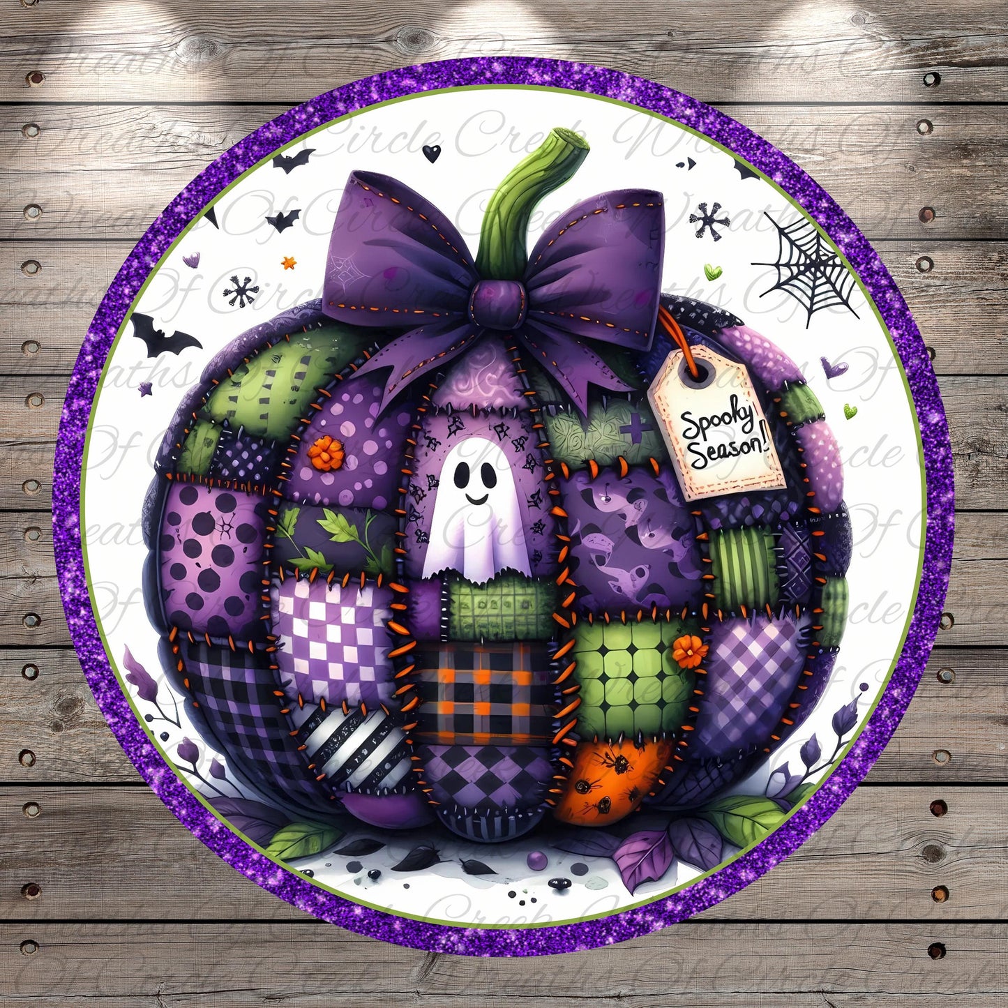 A patchwork pumpkin with a purple bow, surrounded by various Halloween-themed elements such as bats, a spider web, and a ghost.