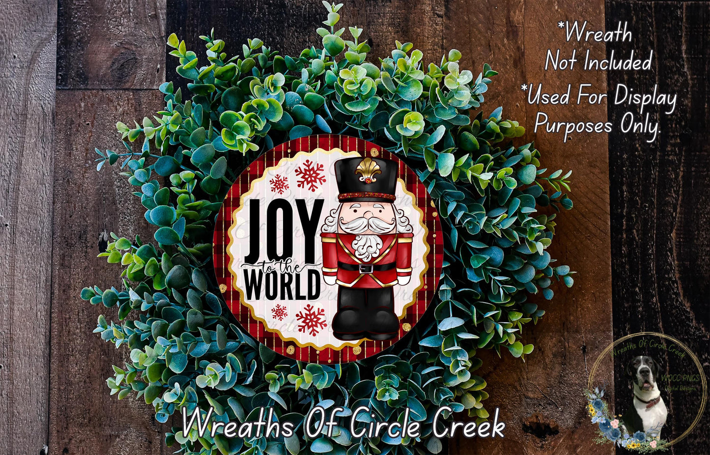 a wreath with a nutcracker figure and the text "Joy to the World" on it, surrounded by greenery.