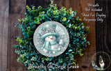 A wreath made of green leaves and a snowman decoration, with a text overlay that reads &quot;Wreath Not Included * Used For Display Purposes Only&quot; and &quot;Wreaths Of Circle Creek&quot;.