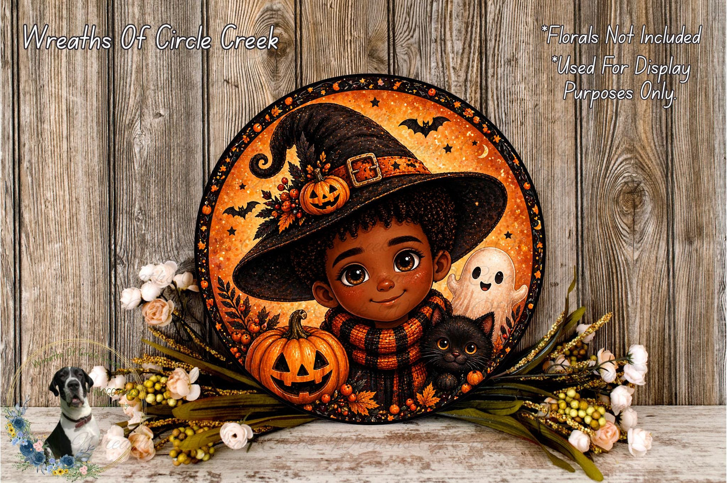 A Halloween-themed wreath featuring a young boy wearing a witch's hat, surrounded by a pumpkin, a ghost, and a cat, with a spooky Halloween backdrop.