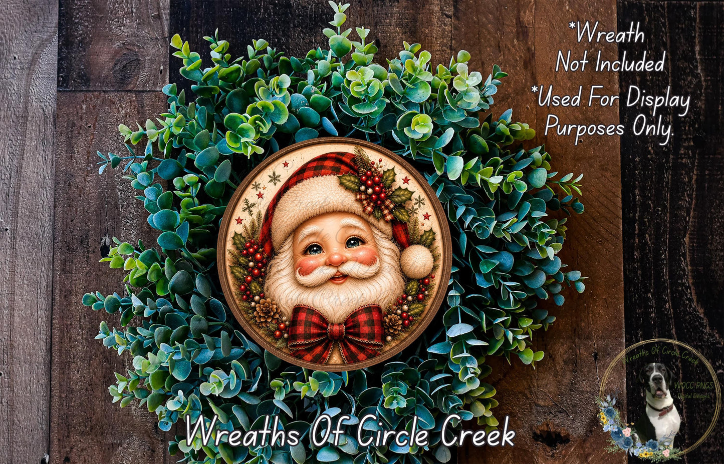 A wreath featuring a painted Santa Claus face surrounded by greenery, with a caption stating that the wreath is not included in a display and is used for purposes only.