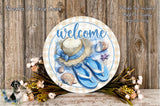 a decorative sign with a welcome message, surrounded by various floral elements and a straw hat.