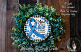 A wreath made of green leaves and a blue ribbon, with the text "in April we wear blue for autism awareness" and "Wreaths of Circle Creek" written on it.