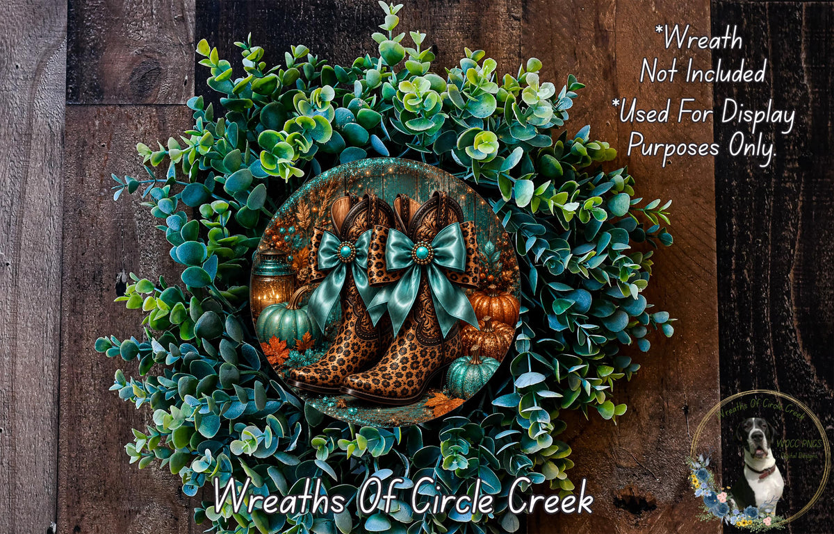 a wreath made of various materials, including green leaves, pumpkins, and leopard print boots. The wreath is displayed on a wooden surface, and there is a small dog in the background.
