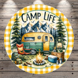 a camping scene with a camper van, camping gear, and a campfire, surrounded by pine trees and mountains in the background.