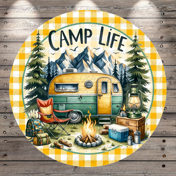 a camping scene with a camper van, camping gear, and a campfire, surrounded by pine trees and mountains in the background.
