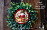 A wreath made of evergreen branches and a snowman, with a lantern and berries as decorations.