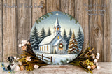 A round wooden plaque depicting a snowy church surrounded by pine trees and a wreath, with a starry night sky in the background.