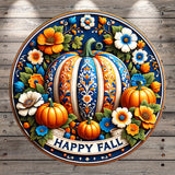 A decorative round plaque with a pumpkin and flowers, surrounded by the text &quot;HAPPY FALL&quot;.