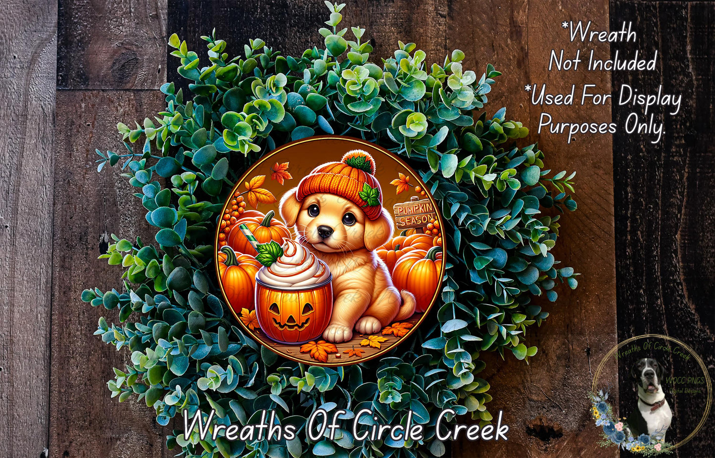 A wreath featuring a cartoon dog wearing a pumpkin hat and holding a pumpkin, surrounded by a lush green plant and other autumn-themed elements.