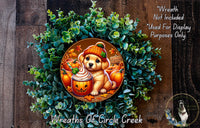 A wreath featuring a cartoon dog wearing a pumpkin hat and holding a pumpkin, surrounded by a lush green plant and other autumn-themed elements.