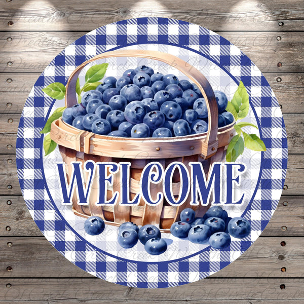 A round sign with a basket of blueberries and the word "WELCOME" written on it.