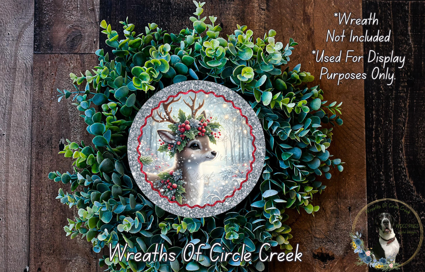 A wreath made of green leaves and a silver deer head, with a red ribbon around the deer's neck.