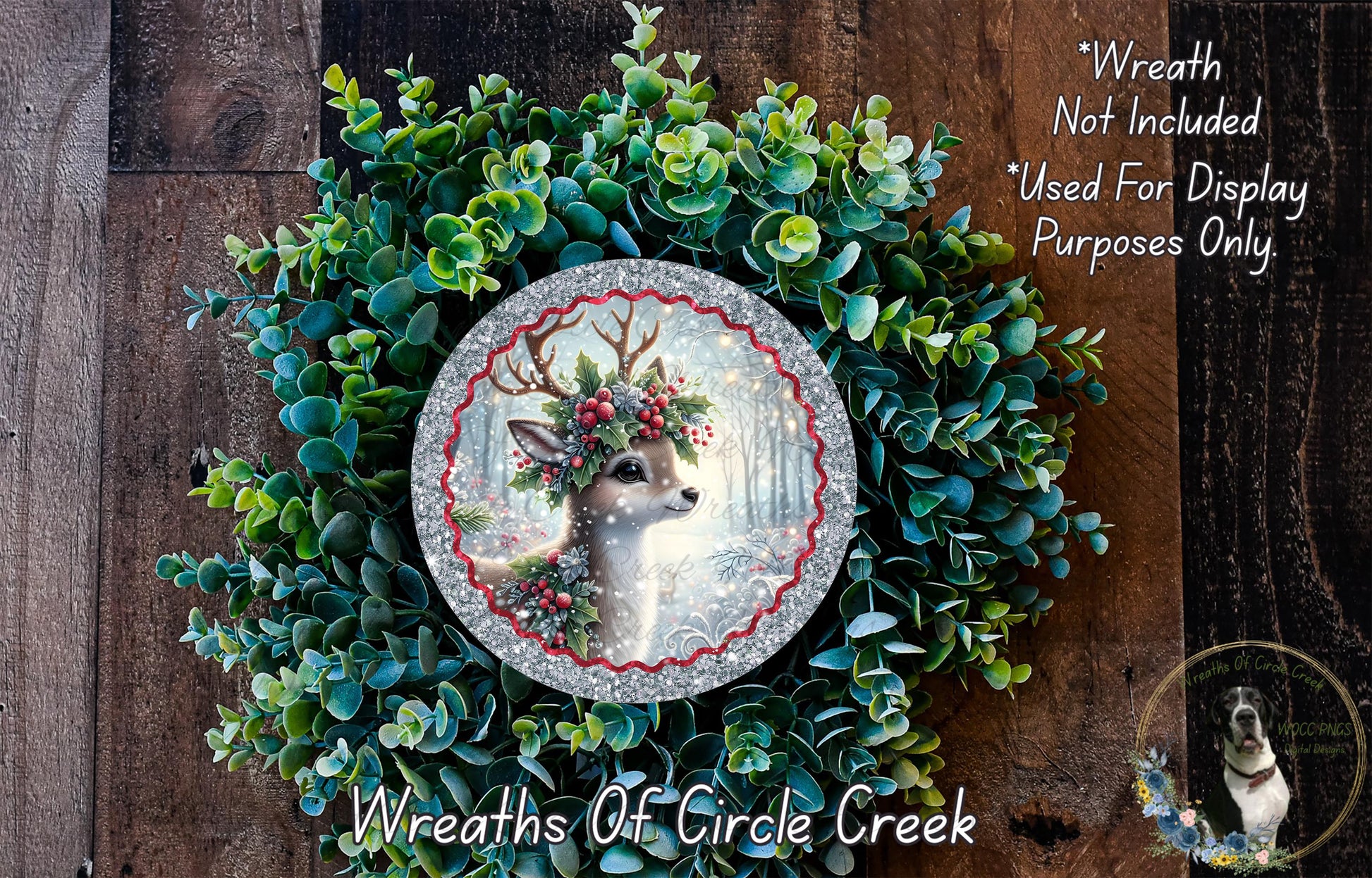 A wreath made of green leaves and a silver deer head, with a red ribbon around the deer's neck.