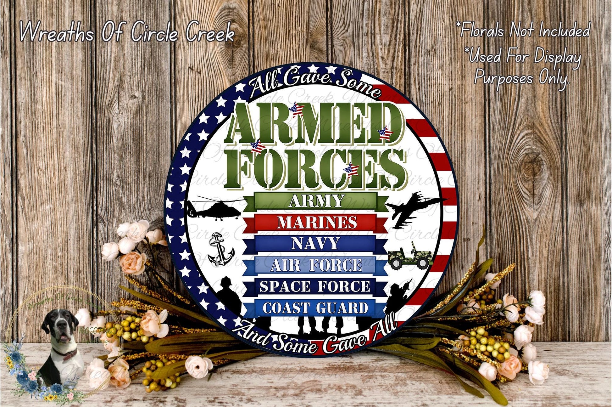 a circular sign with the text "Armed Forces" and various military branches listed on it, surrounded by a wreath of flowers and foliage.