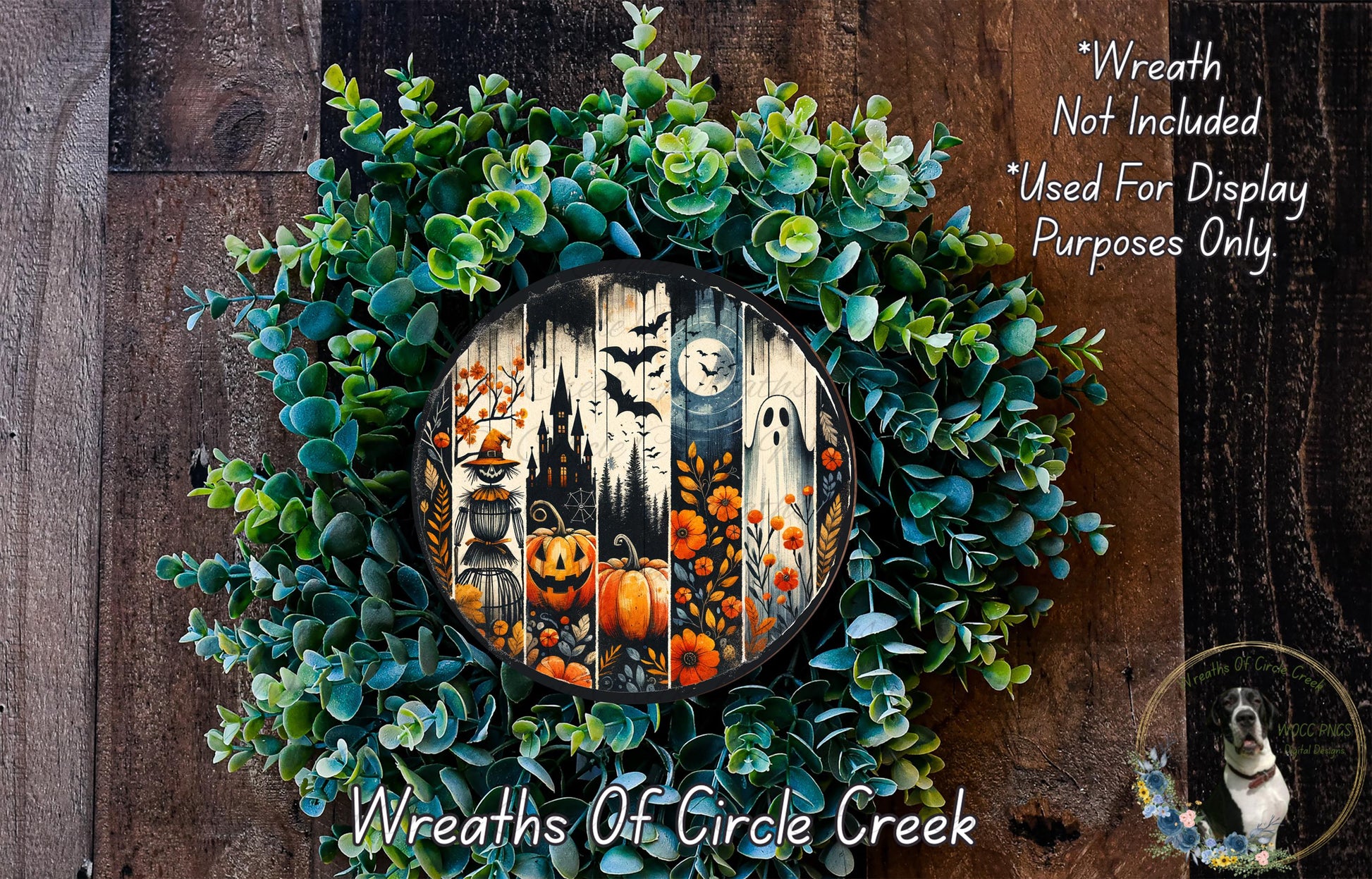 a Halloween-themed wreath made of green foliage and decorated with pumpkins, bats, and a clock. The wreath is displayed on a wooden surface, and there is a small dog in the bottom right corner of the image.