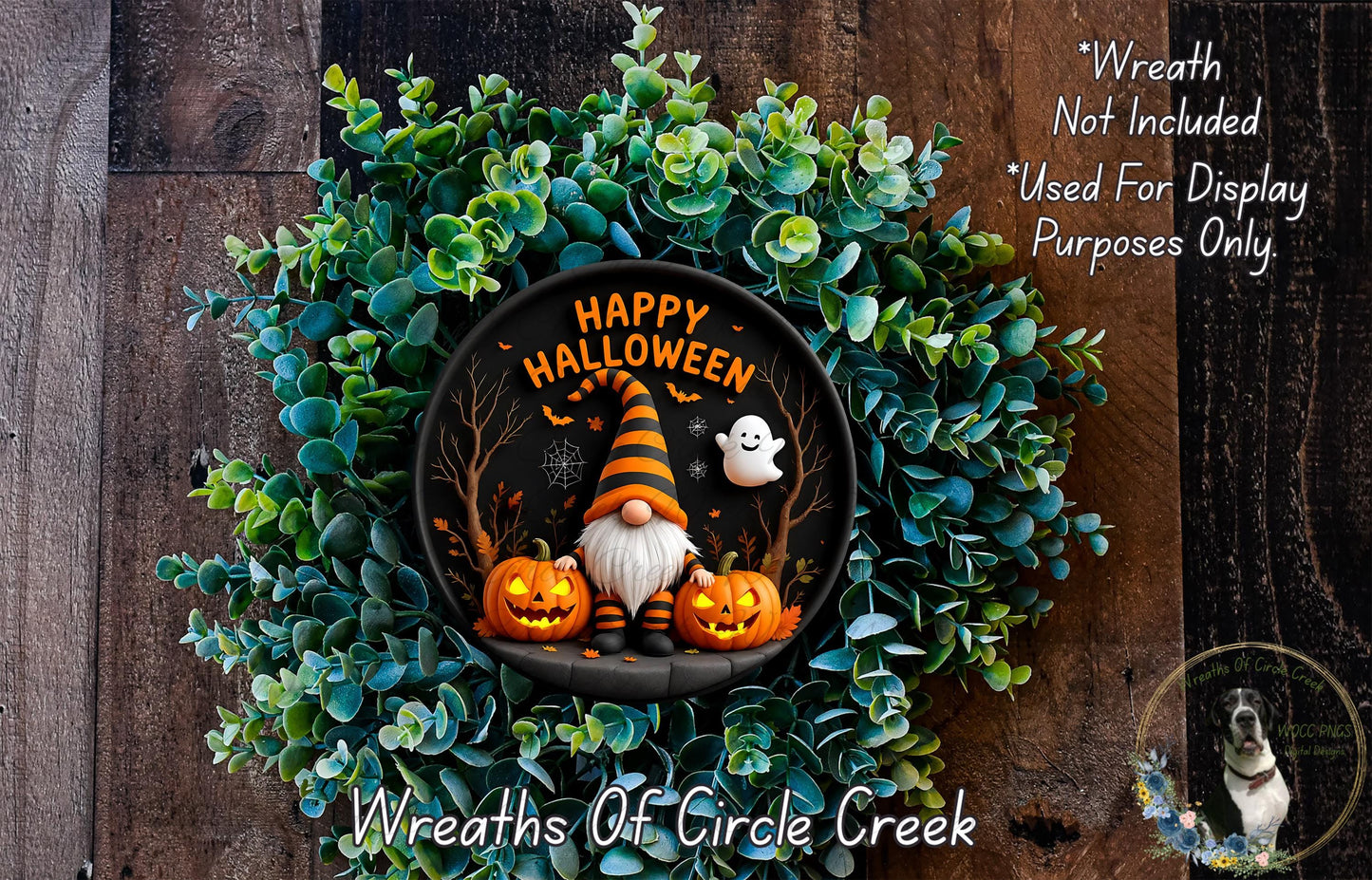 A Halloween-themed wreath made of green foliage and featuring a gnome, pumpkins, and a ghost. The wreath has the text "Happy Halloween" and "Wreath Not Included" written on it.