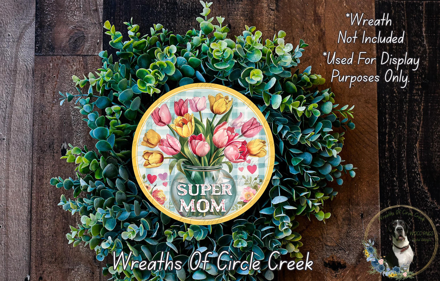 A wreath made of green leaves and flowers, with a round sign in the center that says "SUPER MOM".