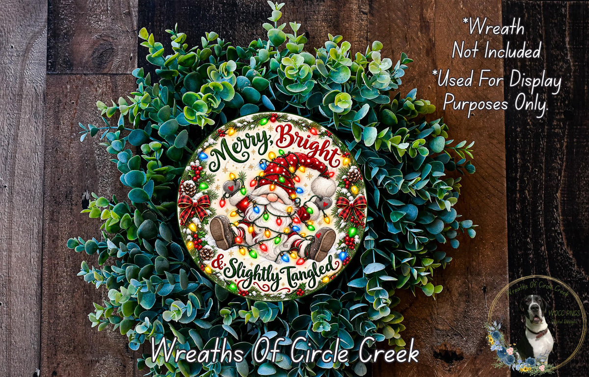 A wreath made of green leaves and a Santa Claus ornament, with the text "Merry Bright & Slightly Tangled" written on it.