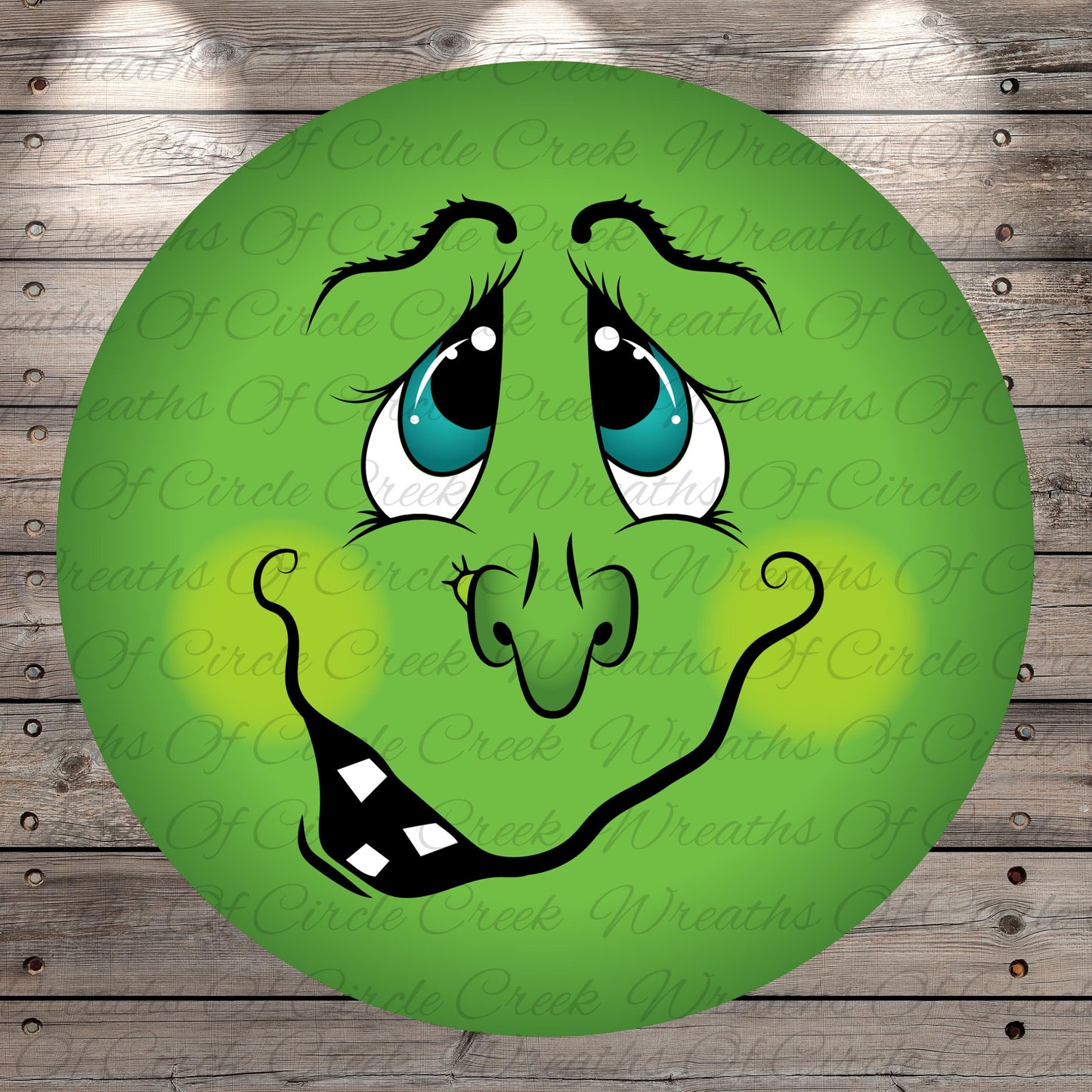A green circle with a smiling, cartoon-like face design on it.
