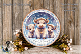 A decorative wooden plaque featuring three cows against a snowy background, surrounded by flowers and greenery.