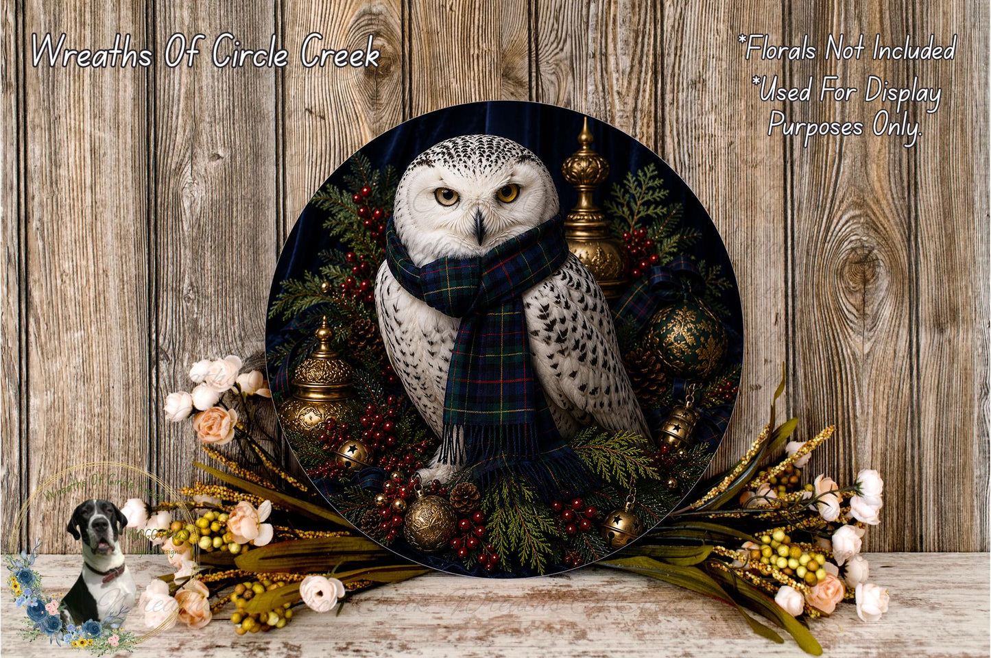 A decorative wreath featuring a white owl wearing a plaid scarf, surrounded by various holiday-themed elements such as berries, pine cones, and ornaments.
