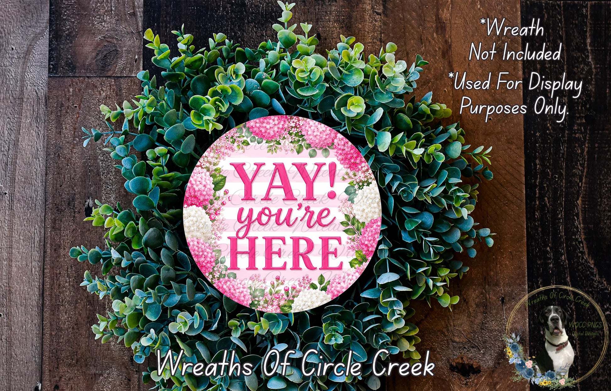a wreath made of green leaves and flowers, with a pink circular sign that says "YAY! you're here".