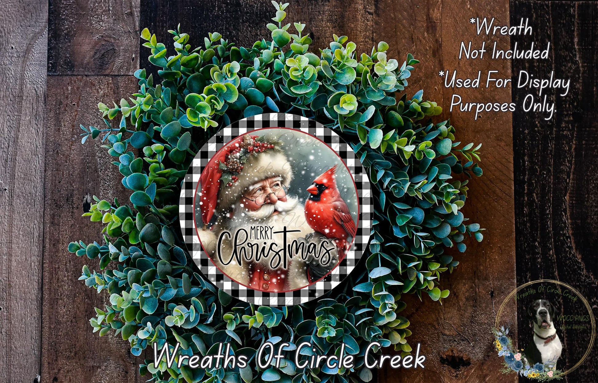 A Christmas wreath made of evergreen branches and a red cardinal bird, with a Santa Claus image in the center. The wreath is displayed on a wooden background, and there is text indicating that the wreath is not included in a display and is used only for purposes.
