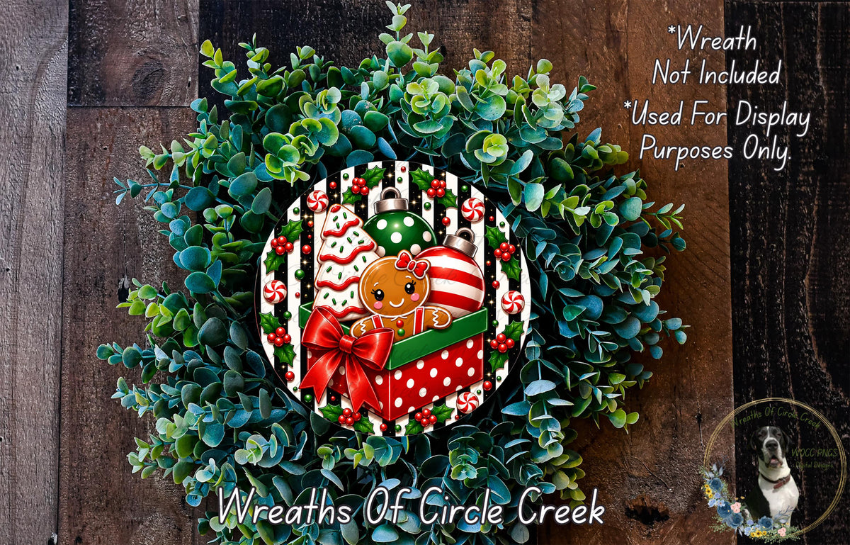 A wreath made of green leaves and a gingerbread man, with a red bow and candy canes, is displayed on a wooden surface.