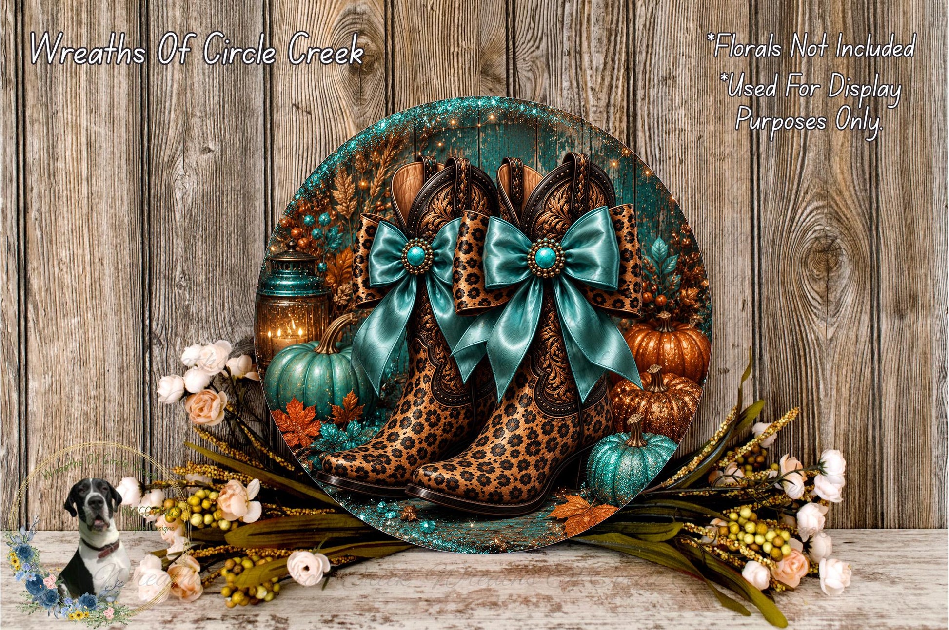A decorative wreath featuring leopard print boots, turquoise bows, pumpkins, and other fall-themed elements, displayed on a wooden surface.