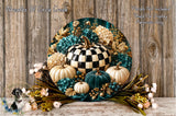 A decorative wreath made of various materials, including a large black and white checkerboard pumpkin, white pumpkins, blue and green flowers, and other fall-themed elements, displayed on a wooden surface.