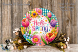 A colorful, decorative wreath with the text "Hello Spring" displayed on it, surrounded by various flowers and foliage. The wreath is placed on a wooden surface, and there are some flowers and greenery visible in the foreground.