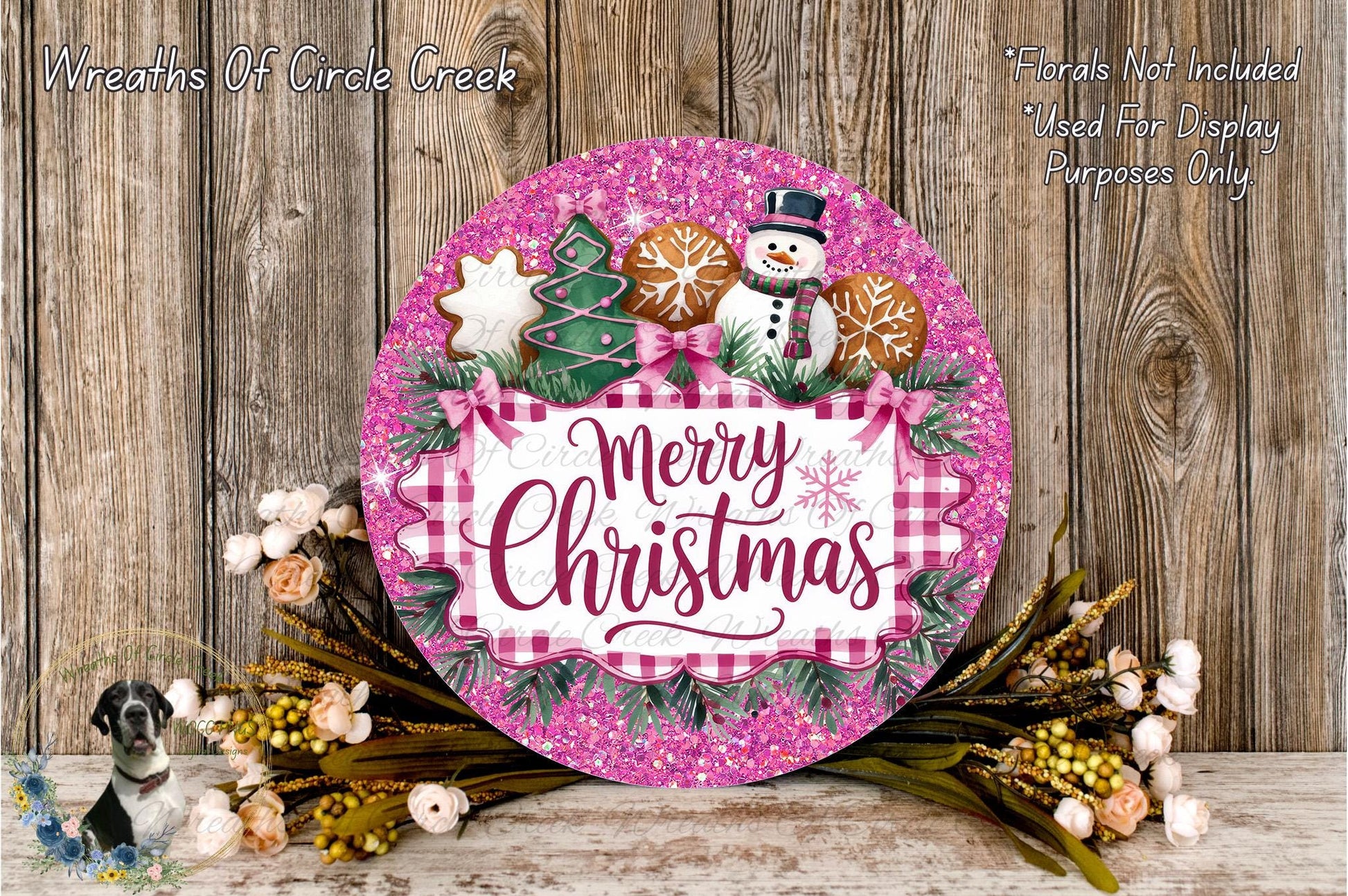 A festive Christmas wreath with a snowman, gingerbread cookies, and a "Merry Christmas" sign, surrounded by flowers and greenery.