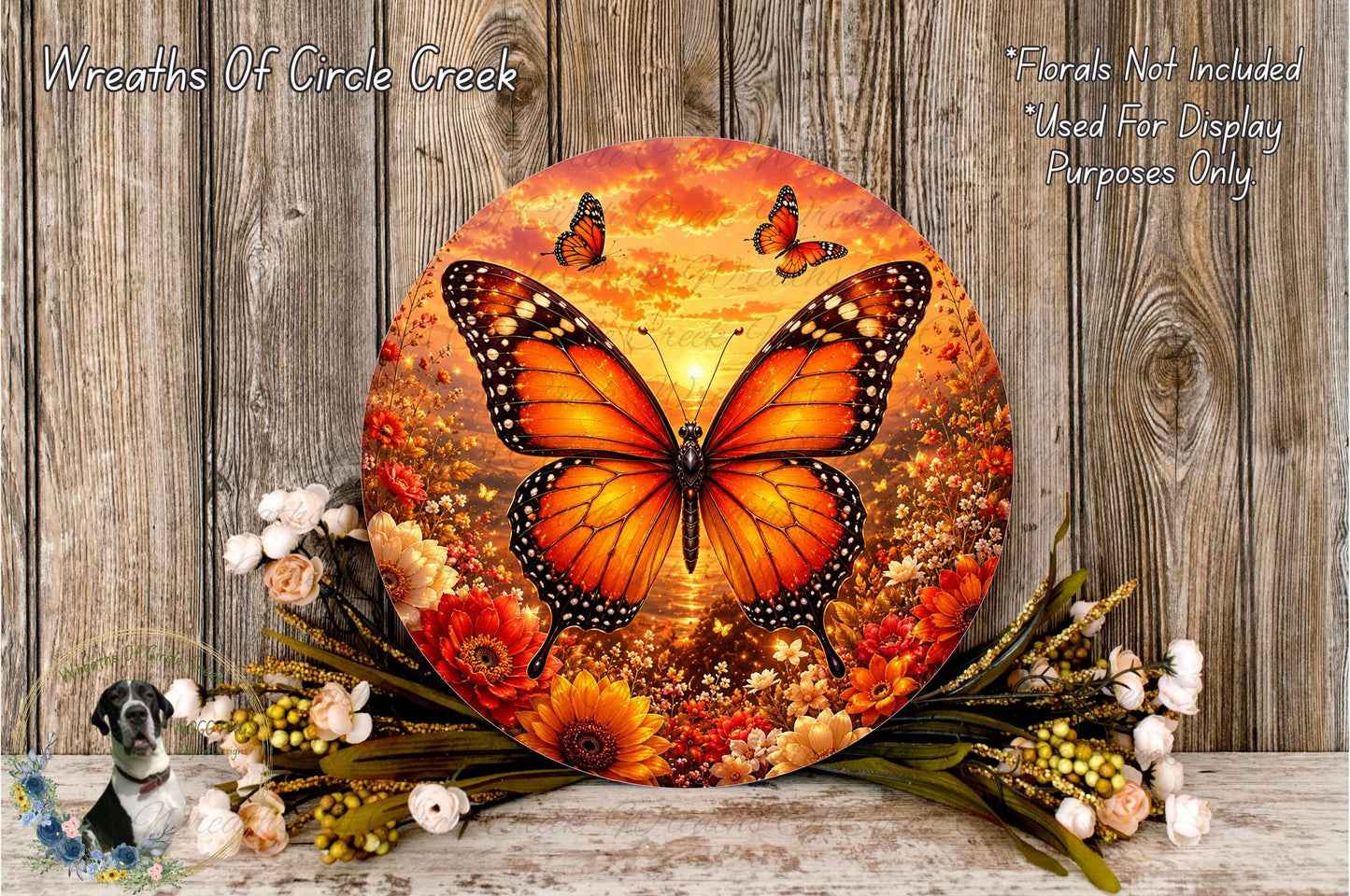 a large circular wreath with a vibrant butterfly design, surrounded by a variety of colorful flowers and foliage.