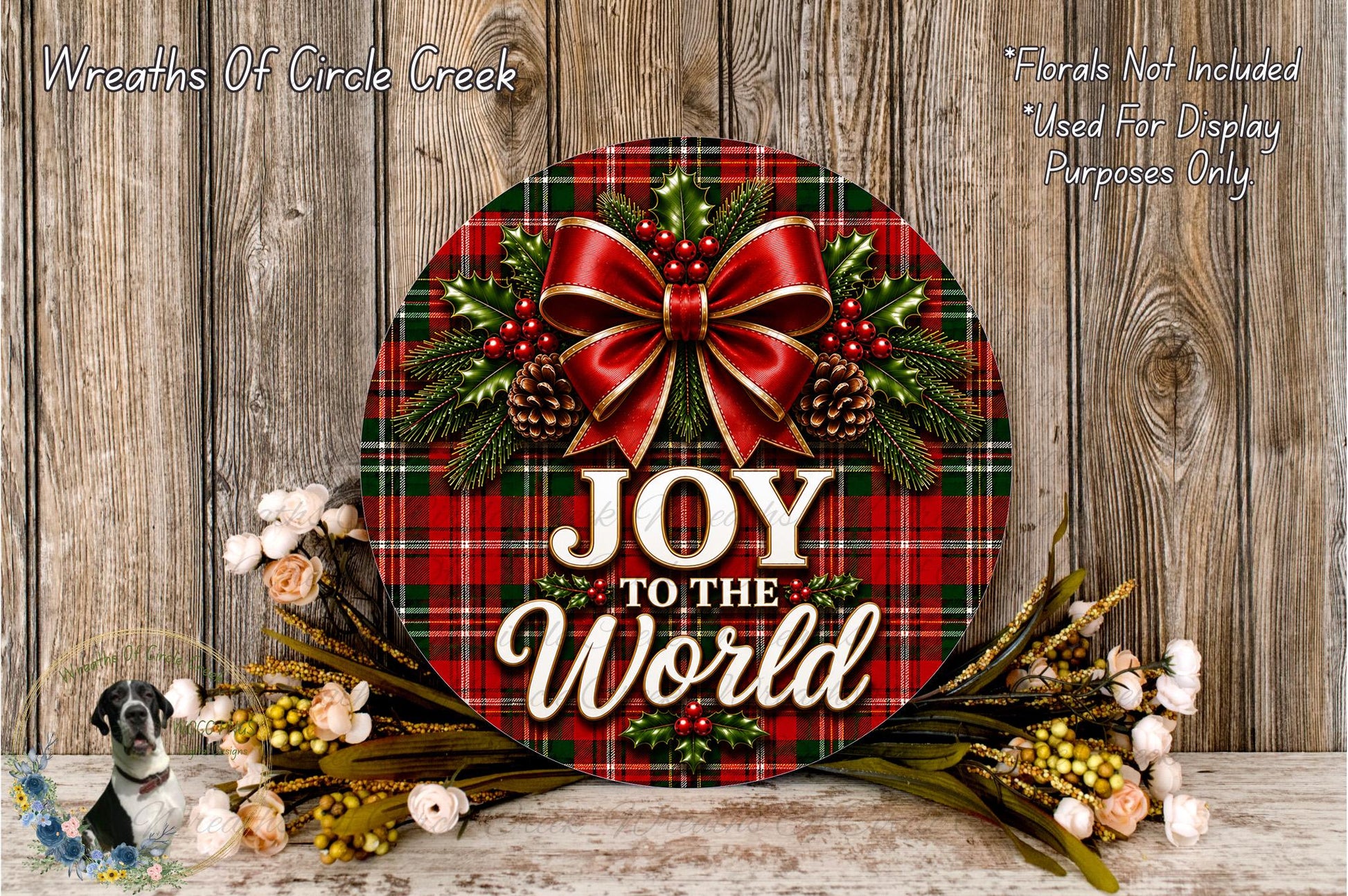 A festive wreath with a red bow and the text "Joy to the World" displayed on it, surrounded by various holiday decorations such as pine cones, flowers, and greenery.