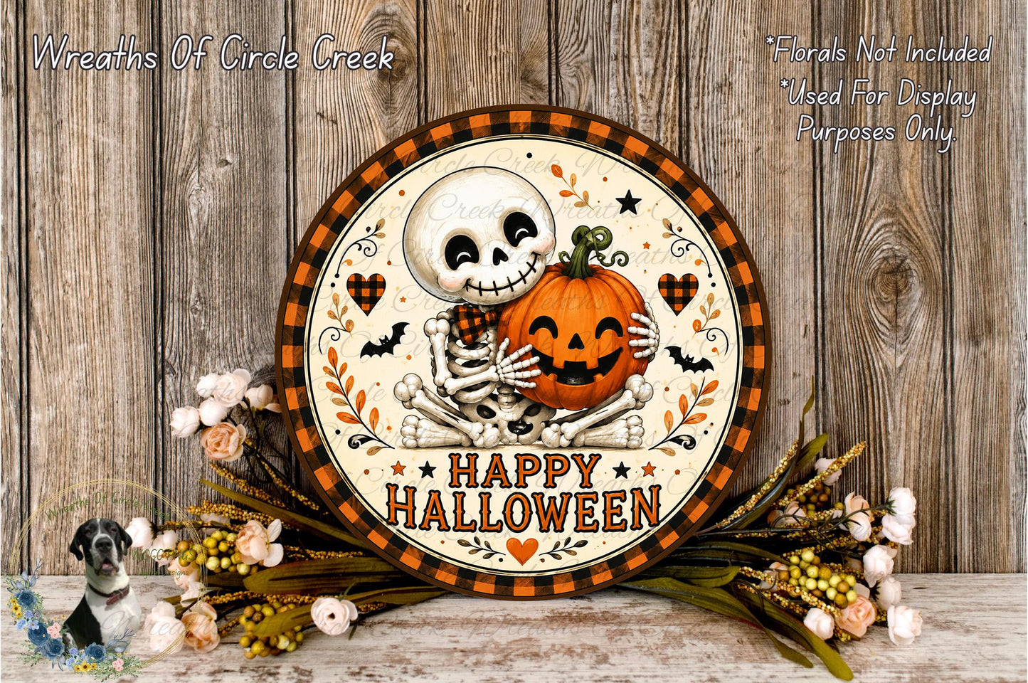A Halloween-themed wreath with a skeleton holding a jack-o-lantern, surrounded by flowers and a wooden background.