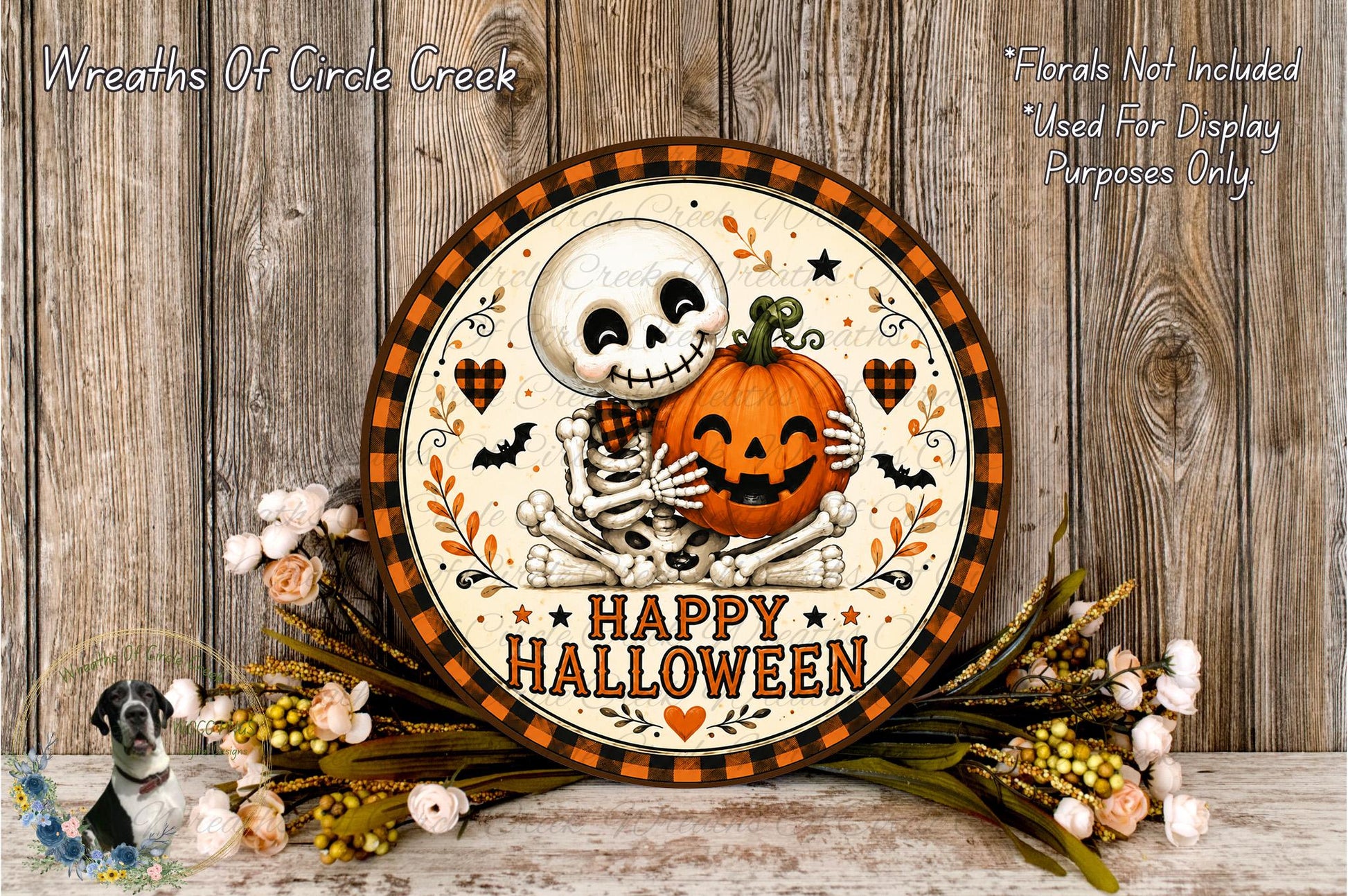 A Halloween-themed wreath with a skeleton holding a jack-o-lantern, surrounded by flowers and a wooden background.