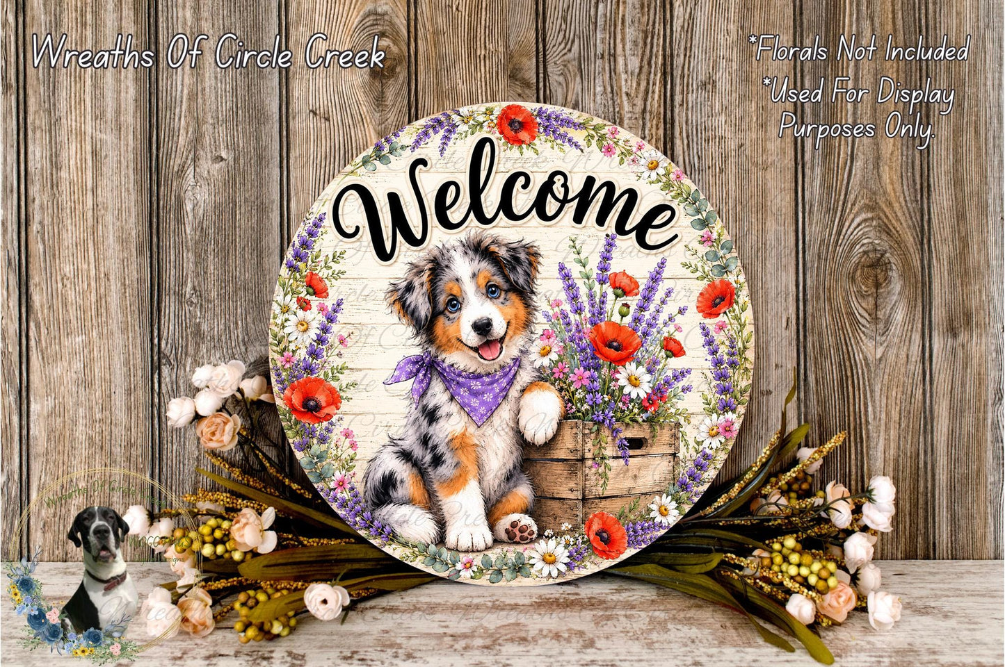 A decorative welcome sign featuring a dog surrounded by flowers and a wooden crate, placed on a wooden surface.
