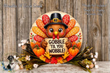 A wooden sign featuring a cartoon turkey holding a sign that says "GOBBLE 'TIL YOU WOBBLE!" surrounded by autumn decorations such as pumpkins, leaves, and flowers.