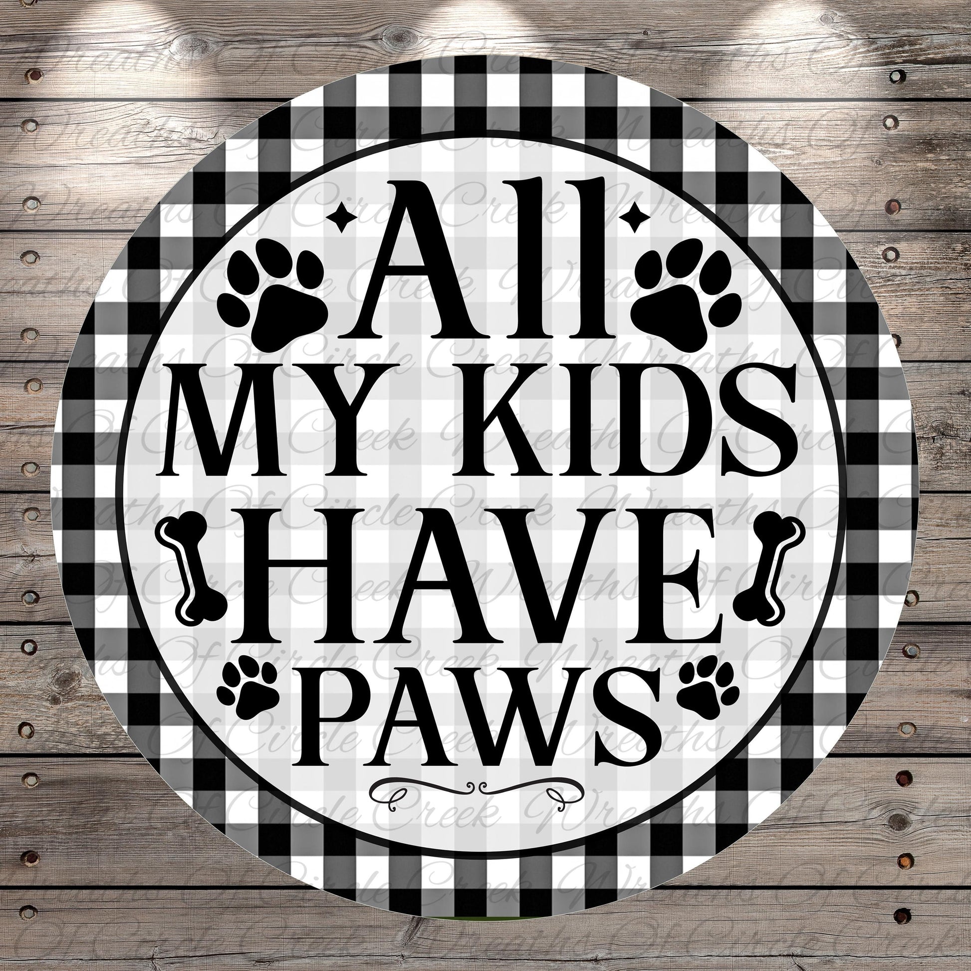 A circular sign with the text "ALL MY KIDS HAVE PAWS" in bold letters, surrounded by paw prints and bones.