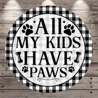 A circular sign with the text "ALL MY KIDS HAVE PAWS" in bold letters, surrounded by paw prints and bones.