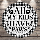 A circular sign with the text "ALL MY KIDS HAVE PAWS" in bold letters, surrounded by paw prints and bones.