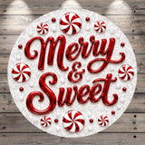A circular arrangement of red and white candy pieces, with the text "Merry & Sweet" prominently displayed in the center.